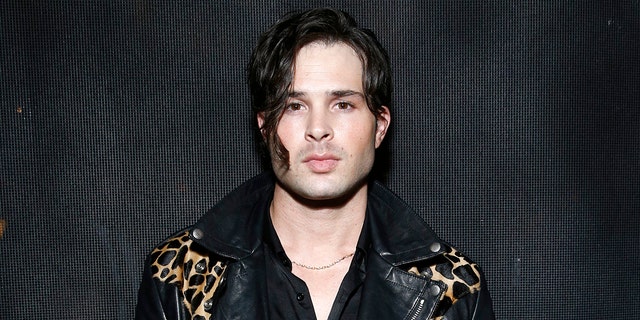 Cody Longo wears black leather jacket embroidered with leopard print