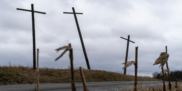 Three crosses stand on a hillside overlooking a farm on the state line of Ohio and Pennsylvania following a train derailment prompting health concerns on Feb. 17, 2023, in East Palestine, Ohio. 