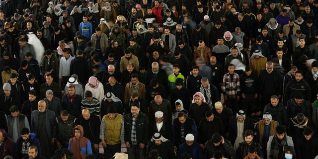 Shiite worshippers gather at the golden-domed shrine of Imam Moussa al-Kadhim, who died at the end of the eighth century, during the annual commemoration of the saint's death, in Baghdad, Iraq, on Feb. 15, 2023.