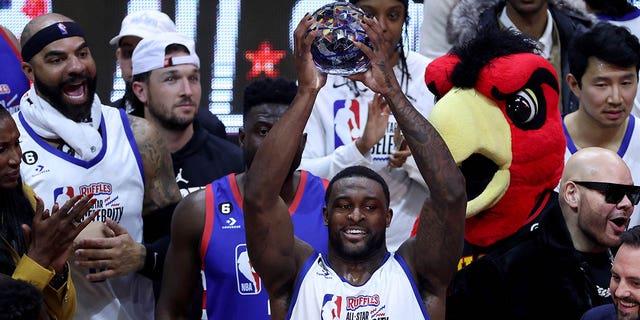 DK Metcalf of Team Dwayne hoists the MVP trophy after the NBA All Star Ruffles Celebrity Game at Vivint Arena on Feb. 17, 2023, in Salt Lake City, Utah.