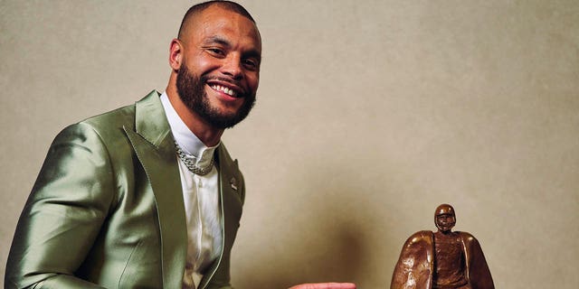 Dak Prescott poses for a photo after winning the Walter Payton Man of the Year award during the NFL Honors at Symphony Hall on February 9, 2023 in Phoenix, Arizona. 