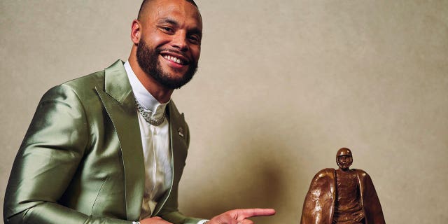 Dak Prescott poses for a photo after winning the Walter Payton Man of the Year award during the NFL Honors at Symphony Hall on February 9, 2023 in Phoenix, Arizona. 