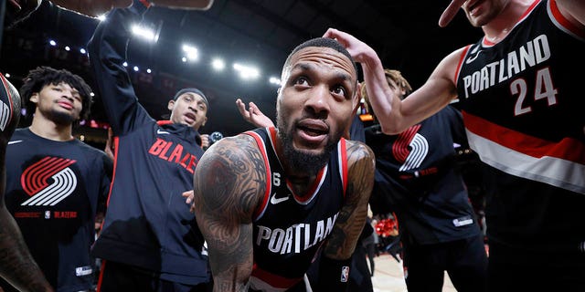 Damian Lillard #0 of the Portland Trail Blazers celebrates with teammates after a 134-124 victory over the Utah Jazz at Moda Center on January 25, 2023 in Portland, Oregon.