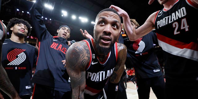 Damian Lillard, #0 of the Portland Trail Blazers, celebrates with teammates after a 134-124 victory over the Utah Jazz at the Moda Center on January 25, 2023 in Portland, Oregon.