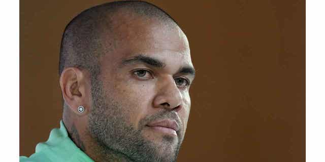 Brazil's Dani Alves listens to a question during a World Cup press conference in Doha, Qatar, on Dec. 1, 2022. Alves has agreed to wear a tracking device and turn in his passport if he is set free, as a sexual assault investigation against him continues.