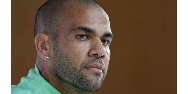 Brazil's Dani Alves listens to a question during a World Cup press conference in Doha, Qatar, on Dec. 1, 2022. Alves has agreed to wear a tracking device and turn in his passport if he is set free, as a sexual assault investigation against him continues.