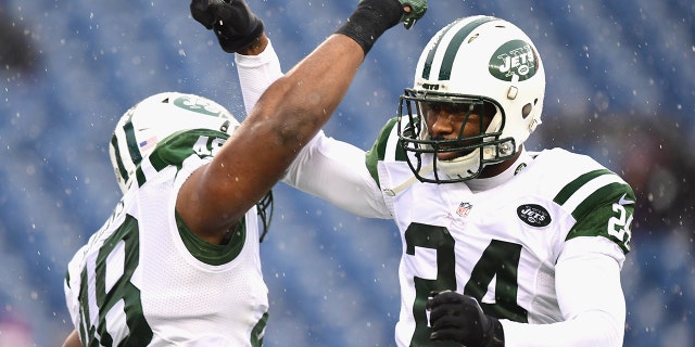 Darrelle Revis #24 of the New York Jets reacts with Jordan Jenkins #48 before a game against the New England Patriots at Gillette Stadium on December 24, 2016 in Foxboro, Massachusetts.