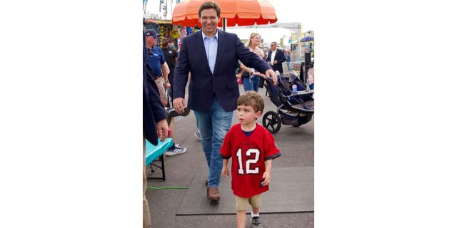 Republican Florida Gov. Ron DeSantis and son, Mason, at the Florida state fair in Tampa on February 9, 2023.