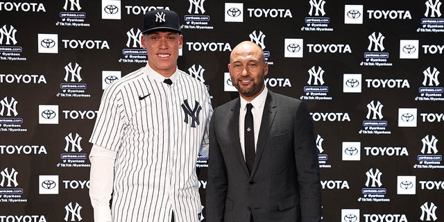 New York Yankees' Aaron Judge, left, poses for a photo with Derek Jeter after a news conference at Yankee Stadium on December 21, 2022 in the Bronx, New York.