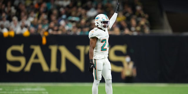 Byron Jones of the Miami Dolphins raises an arm during the New Orleans Saints game at Caesars Superdome on December 27, 2021 in New Orleans.