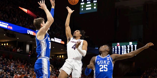 Virginia's Armaan Franklin (4) shoots the ball between Duke's Kyle Filipowski (30) and Mark Mitchell (25) during the second half of a game in Charlottesville, Va., Saturday, Feb. 11, 2023. 