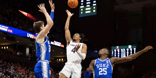 Virginia's Armaan Franklin (4) shoots the ball between Dukes Kyle Filipowski (30) and Mark Mitchell (25) during the second half of a game in Charlottesville, Va., Saturday February 11, 2023.
