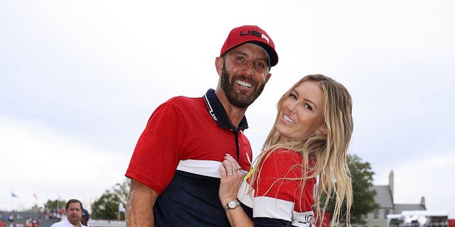 Dustin Johnson of team United States celebrates with wife Paulina Gretzky after defeating Team Europe 19 to 9 during Sunday Singles Matches of the 43rd Ryder Cup at Whistling Straits on September 26, 2021, in Kohler, Wisconsin.