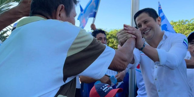 Mayoral candidate Omar Menéndez, right, with supporters in Ecuador wins election following his murder.