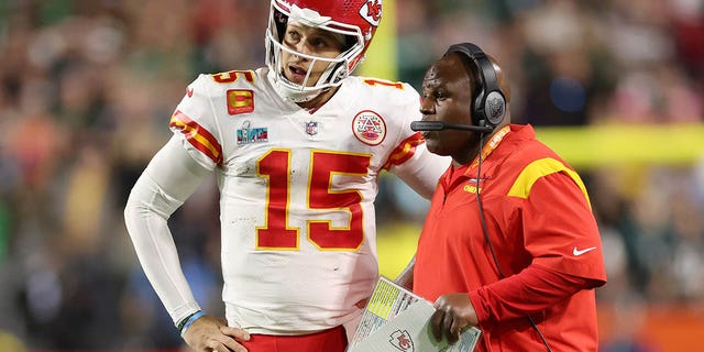 Patrick Mahomes #15 of the Kansas City Chiefs talks with offensive coordinator Eric Bienemi during the fourth quarter against the Philadelphia Eagles in Super Bowl LVII at State Farm Stadium on February 12, 2023 in Glendale, Arizona. 
