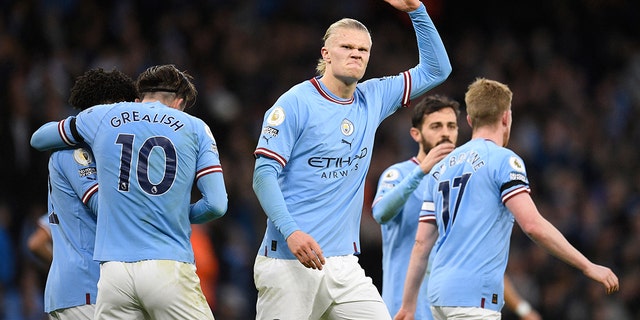 Manchester City's Norwegian striker Erling Haaland gestures to supporters after scoring the first goal in the match against Everton at the Etihad Stadium in Manchester, England on December 31, 2022.