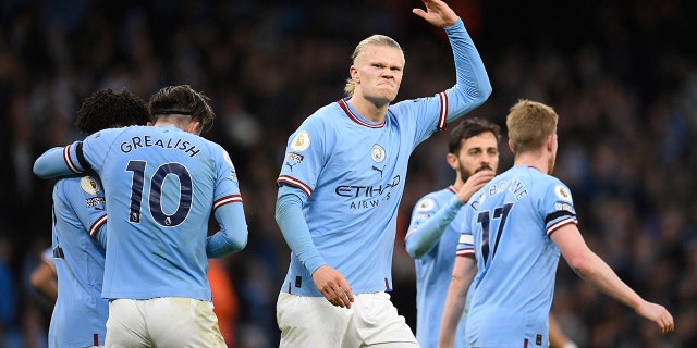 Manchester City's Norwegian striker Erling Haaland gestures to supporters after scoring the opening goal in the match against Everton at the Etihad Stadium in Manchester, England, on Dec. 31, 2022.