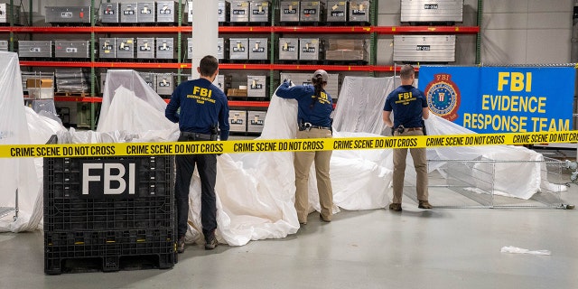 FBI agents process material recovered from the Chinese spy craft recovered off the coast of South Carolina. The material was transported to the FBI Laboratory in Quantico, Virginia.