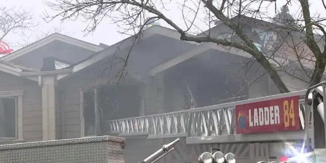 Firefighters battle a blaze at a Staten Island, New York home Friday. 