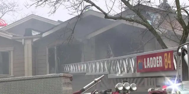 Firefighters battle a blaze at a Staten Island, New York home Friday.
