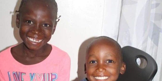 Retrato de dos niños haitianos adoptados, Peterson de cinco años y Gina de seis, esperando pasaportes para poder ingresar a Estados Unidos