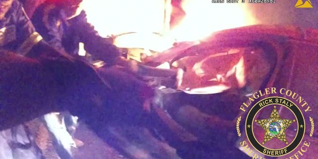 Flagler County Sheriff's rescue a civilian trapped in a fiery wreck