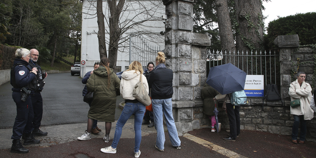 Police officers stood outside the entrance of the Saint Thomas d'Aquin school in Saint-Jean-de-Luz, France, following the stabbing there on Wednesday, Feb. 22, 2023.