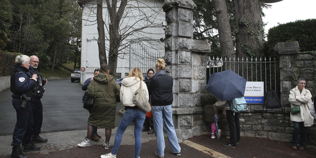 Police officers stood outside the entrance of the Saint Thomas d'Aquin school in Saint-Jean-de-Luz, France, following the stabbing there on Wednesday, Feb. 22, 2023.