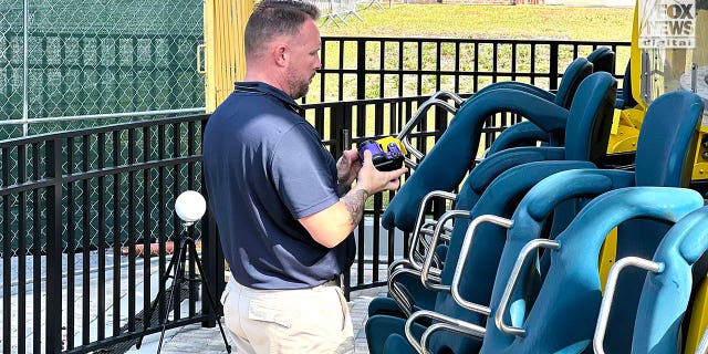 Representatives Austrian ride manufacturer, Funtime Handels inspect the Freefall drop tower ride at Icon Park in Orlando Florida, Thursday, February, 23, 2023. Ride goer, Tyree Sampson died when he fell from the ride in March last year. A man uses a camera to document the inspection. 