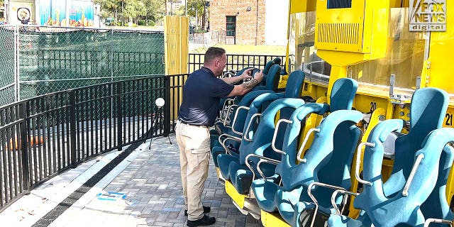 Representatives Austrian ride manufacturer, Funtime Handels inspect the Freefall drop tower ride at Icon Park in Orlando Florida, Thursday, February, 23, 2023. Ride goer, Tyree Sampson died when he fell from the ride in March last year. A man uses a camera to document the inspection. 
