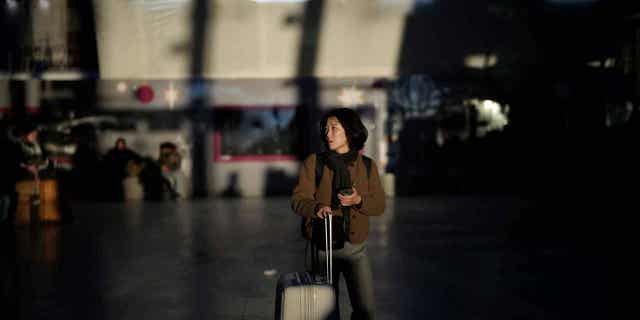 A passenger waits at the Gare de Lyon station in Paris, France, on Feb. 7, 2023. The French parliament has started debating the president's unpopular pension reform proposals, which prompted strikes in recent weeks.