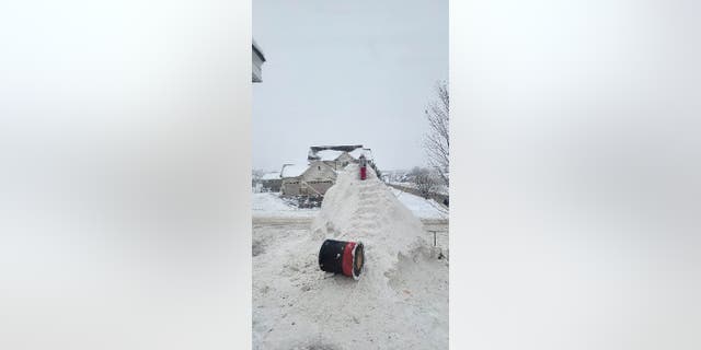 A temporary snow staircase was built behind the giant snowman the Fobbe family built in their front yard.