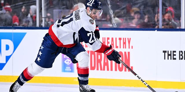 Garnet Hathaway of the Washington Capitals controls the puck against the Carolina Hurricanes during the second period in the 2023 Navy Federal Credit Union NHL Stadium Series at Carter-Finley Stadium Feb. 18, 2023, in Raleigh, N.C.