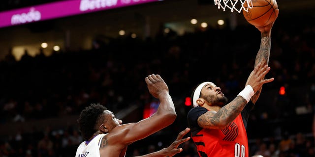 Gary Payton II (00) of the Portland Trail Blazers shoots against Thomas Bryant of the Los Angeles Lakers during the third quarter at the Moda Center on January 22, 2023 in Portland, Oregon.
