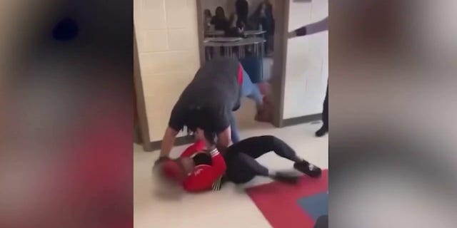 A student is seen pulling Heritage High School teacher Tiwana Turner to the ground during a fight.