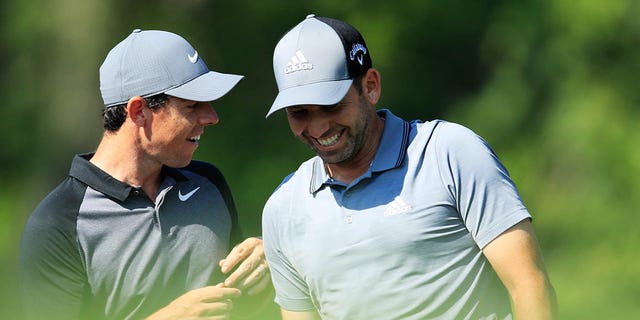 Rory McIlroy, left, talks with Sergio Garcia on the 12th tee during a practice round prior to the 2018 PGA Championship at Bellerive Country Club on Aug. 8, 2018 in St Louis, Missouri.