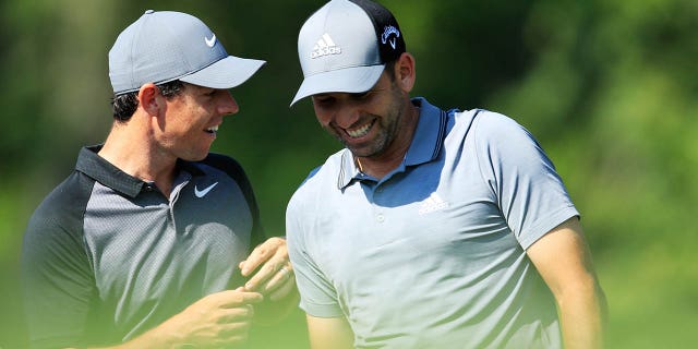 Rory McIlroy, left, talks with Sergio Garcia on the 12th tee during a practice round prior to the 2018 PGA Championship at Bellerive Country Club on Aug. 8, 2018 in St Louis, Missouri.