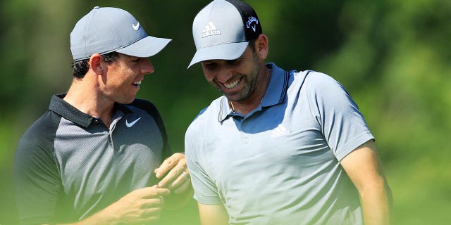 Rory McIlroy, left, talks with Sergio Garcia on the 12th hole during a practice round before the 2018 PGA Championship at Bellerive Country Club on August 8, 2018 in St Louis, Missouri.