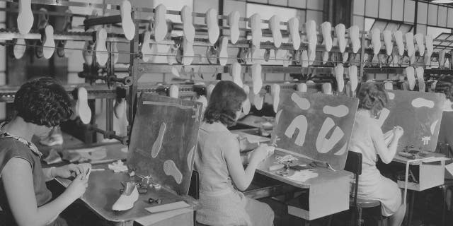 Workers making rubber footwear at the B. F. Goodrich Company factory in Akron, Ohio, USA, circa 1935. Founded in 1870 as Goodrich, Tew and Co. by Dr. Benjamin Franklin Goodrich, the company changed its name to the B.F. Goodrich Company in 1880, to BFGoodrich in the 1980s, and to Goodrich Corporation in 2001.