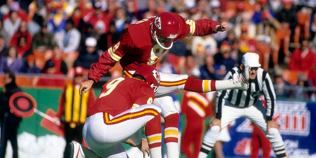 Kansas City Chiefs kicker Nick Lowy #8 kicks a field goal that punter Brian Barker #9 catches during an NFL football game at Arrowhead Stadium in Kansas City, Missouri circa 1993.  Lowry played for the Chiefs from 1980–93.