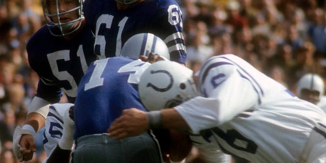 Fred Miller, #76 of the Baltimore Colts, sacks quarterback Craig Morton, #14 of the Dallas Cowboys, during Super Bowl V at the Orange Bowl on January 17, 1971 in Miami.