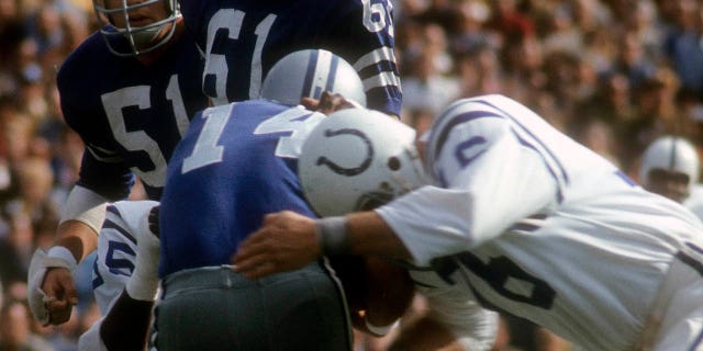 Fred Miller, #76 of the Baltimore Colts, sacks quarterback Craig Morton, #14 of the Dallas Cowboys, during Super Bowl V at the Orange Bowl on January 17, 1971 in Miami.