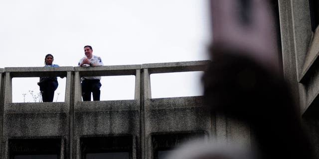 Police officers look on as community members, activists and elected officials convene to demand removal of 330 officers from street duty at a protest at Police Headquarters, in Philadelphia, PA on June 7, 2019.