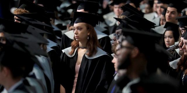 A student waits to receive her degree from the University of Kent during a ceremony at Canterbury Cathedral. (Photo by Gareth Fuller/PA Images via Getty Images)