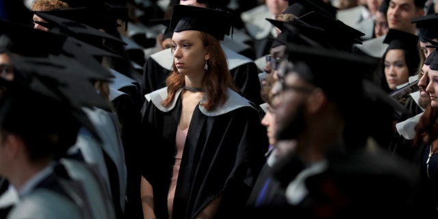 A student waits to receive her degree from the University of Kent during a ceremony at Canterbury Cathedral. (Photo by Gareth Fuller/PA Images via Getty Images)