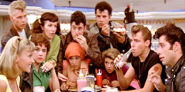 The cast of Grease in a scene at the diner