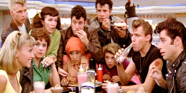 The cast of Grease in a scene at the diner