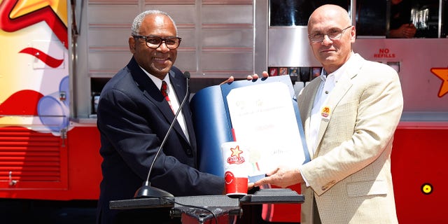 Los Angeles Deputy Mayor Guillermo Cespedes (L) and Andy Puzder, former CEO of CKE Restaurants, parent company of Carl's Jr. attend the Carl's Jr. Celebrates Its 70th Anniversary on July 15, 2011, in Los Angeles, California.