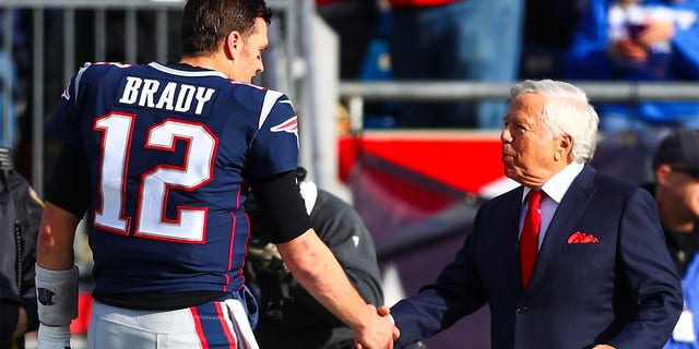 Tom Brady, #12, shakes the hand of New England Patriots owner Robert Kraft before a game against the Miami Dolphins at Gillette Stadium on Dec. 29, 2019 in Foxborough, Massachusetts.