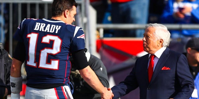 Tom Brady, #12, shakes the hand of New England Patriots owner Robert Kraft before a game against the Miami Dolphins at Gillette Stadium on Dec. 29, 2019 in Foxborough, Massachusetts.